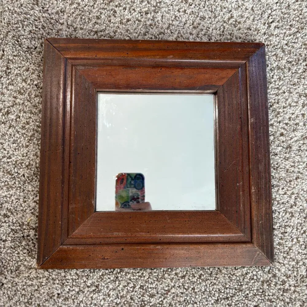 Vintage-style, square wall mirror features a thick, beveled solid wood frame